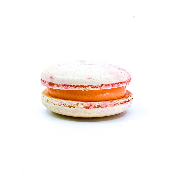 Round lychee macaron with pink and white Ombre colour. Butter cream filling  