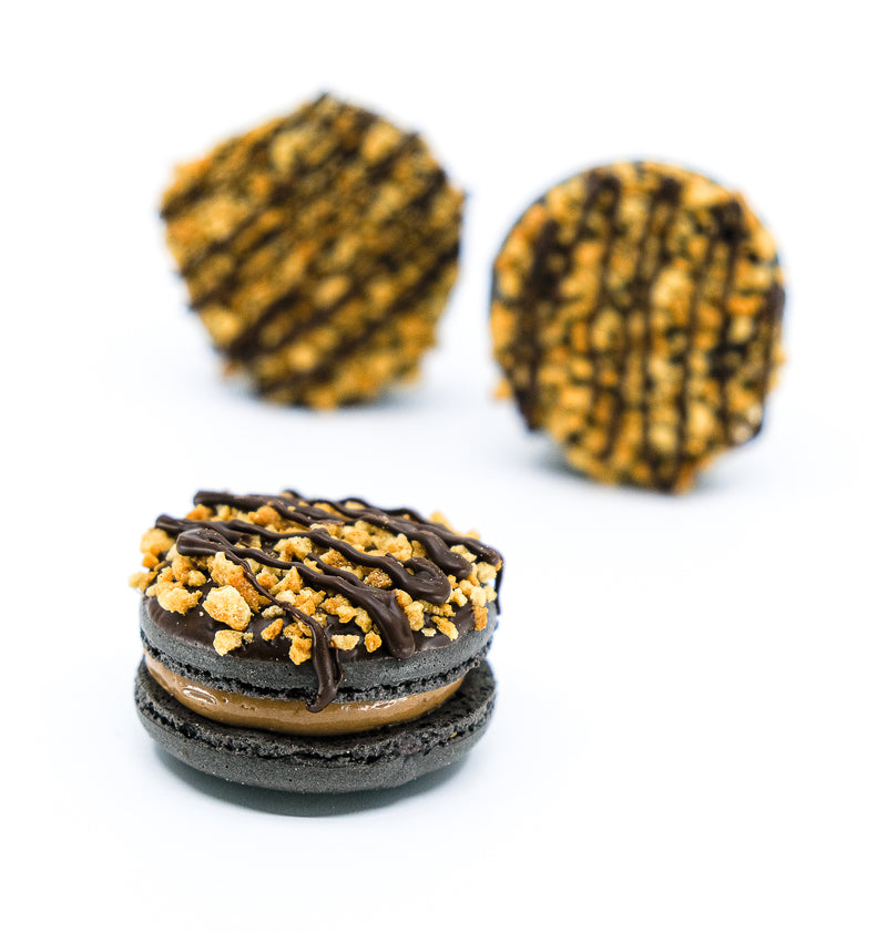 Tim tam Macaron with chocolate drizzled on top and sprinkled nuts