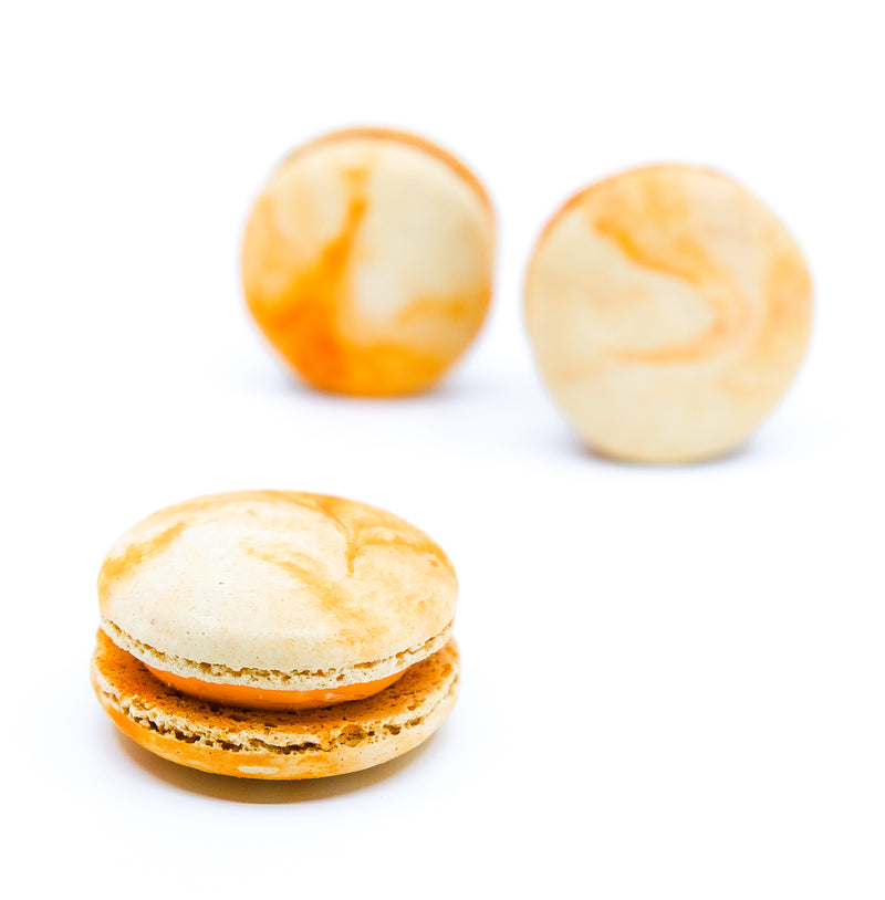 Peach oolong tea flavoured macaron. Orange and white colour