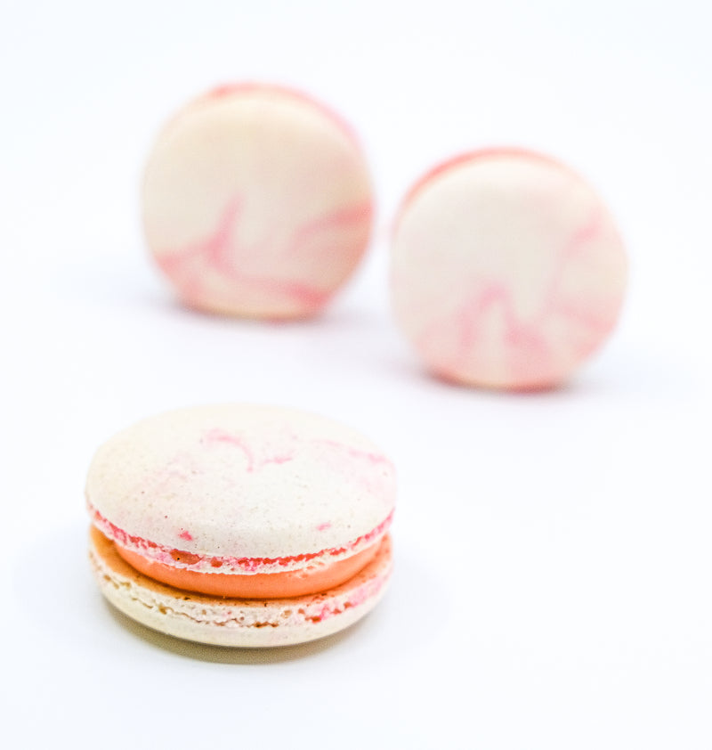 Round lychee macaron with pink and white Ombre colour. Butter cream filling  