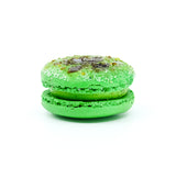 Pandan brulee macaron. Green round macaron with caramalised sugar on top.