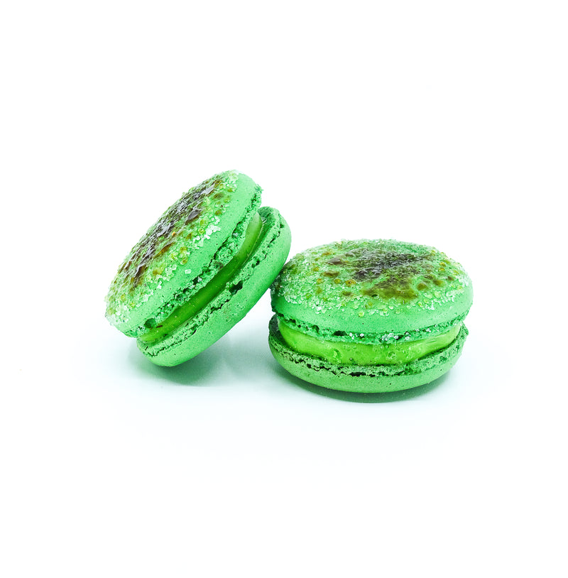 Pandan brulee macaron. Green round macaron with caramalised sugar on top.