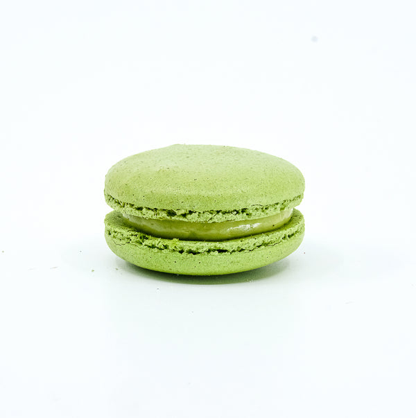 Pistachio flavour round macaron. Light green colour 